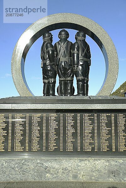 A memorial to coal miners lists the names of men killed in mining accidents in the Greymouth district since 1862. New Zealand  2022. The memorial stands on the Greymouth floodwall and depicts a mine portal with three miners dressed in work clothes