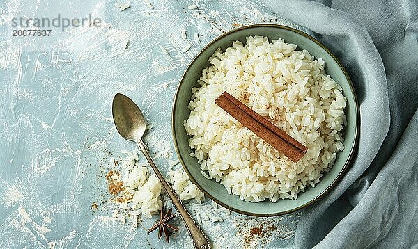 Puerto Rican arroz con dulce with cinnamon on a light blue background AI generated