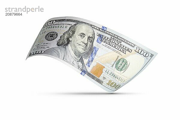 One hundred dollar bill floating down to surface with drop shadow isolated on a white background