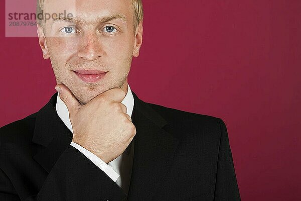 Businessman face on a red background. Closeup