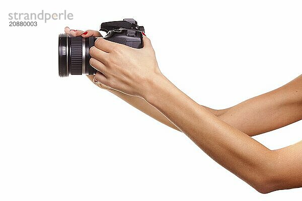 Women's hands holding the camera. Isolated on white