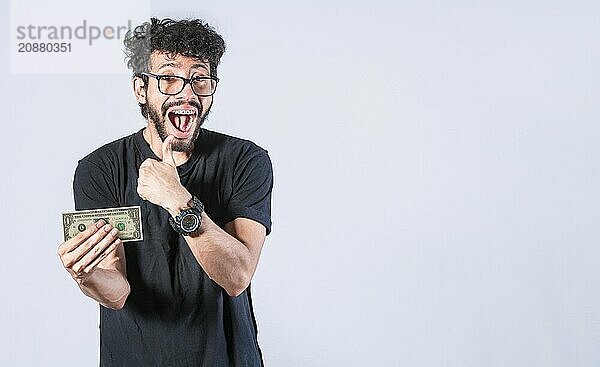 Happy man holding dollar bill looking at camera isolated. Man with banknote isolated