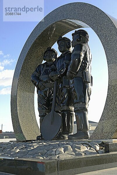 A memorial to coal miners lists the names of men killed in mining accidents in the Greymouth district since 1862. New Zealand  2022. The memorial stands on the Greymouth floodwall and depicts a mine portal with three miners dressed in work clothes