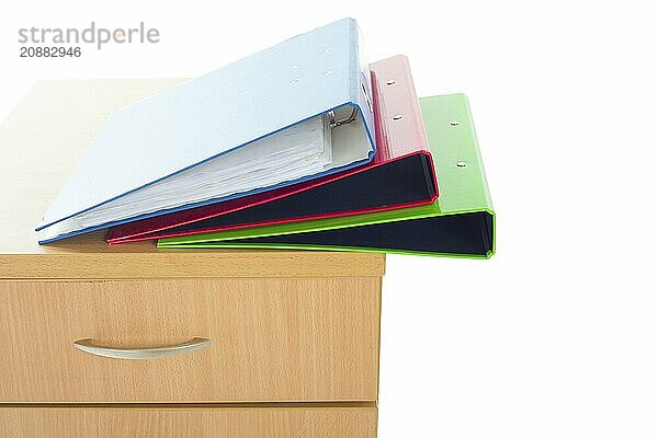 Filing cabinet and folders isolated over white background