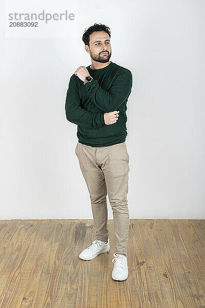 Portrait of a latin man looking to the side. White background