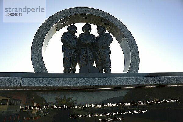 A memorial to coal miners lists the names of men killed in mining accidents in the Greymouth district since 1862. New Zealand  2022. The memorial stands on the Greymouth floodwall and depicts a mine portal with three miners dressed in work clothes