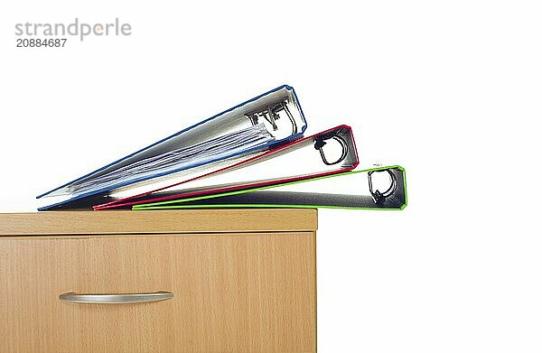 Filing cabinet and folders isolated over white background