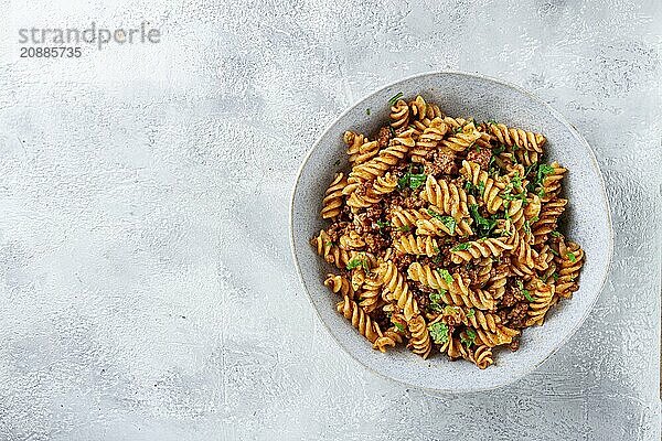 Pasta in navy  pasta with minced meat  gray background  homemade  fusilli pasta  no people