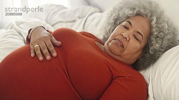 An elderly woman with grey hair is pregnant and lying in bed with her hand on her belly  AI generated