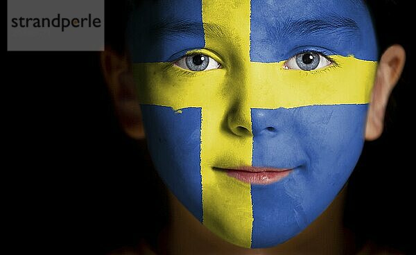 Portrait of a child with a painted swedish flag  closeup