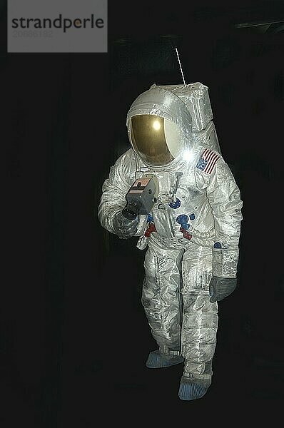 American astronaut in pressure space suit on black background