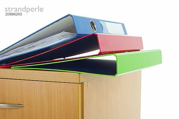 Filing cabinet and folders isolated over white background