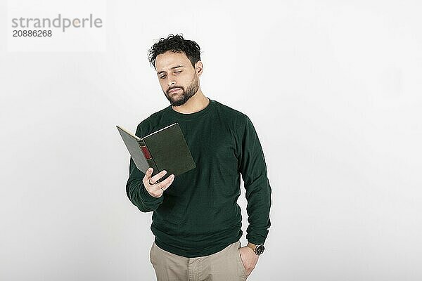 Latin man standing reading. White background