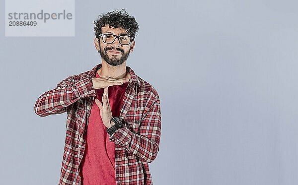 Smiling man gesturing time out isolated. Young Man making time out gesture isolated