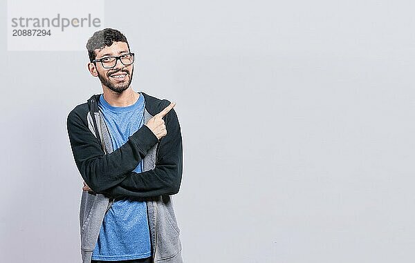 Smiling people pointing a banner to the side isolated. Happy young man pointing fingers to the sides isolated