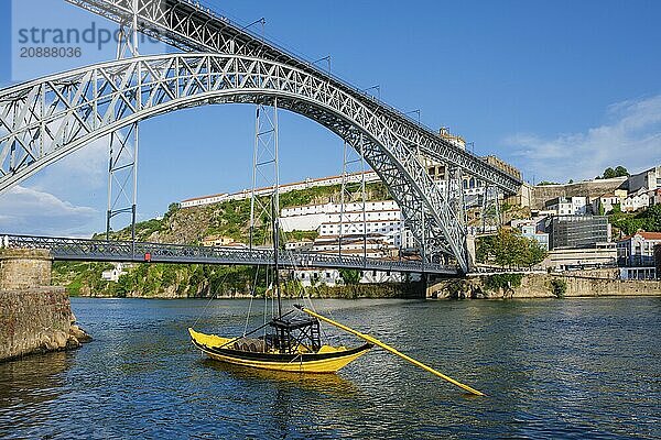 View of Vila Nova de Gaia city with Mosteiro da Serra do Pilar monastery and Dom Luis I bridge over Douro river with traditional boat with port wine barrels. Porto  Vila Nova de Gaia  Portugal  Europe