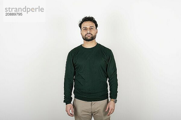 Portrait of young man with serene expression looking at the camera