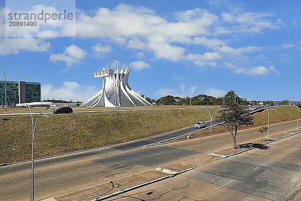 Roman Cathedral of Brasilia or Metropolitan Cathedral of Our Lady of Aparecida  designed by Oscar Niemeyer viewed from an urban highway  Brasília  World Heritage Site  Brasilia  Federal district  Brazil  South America