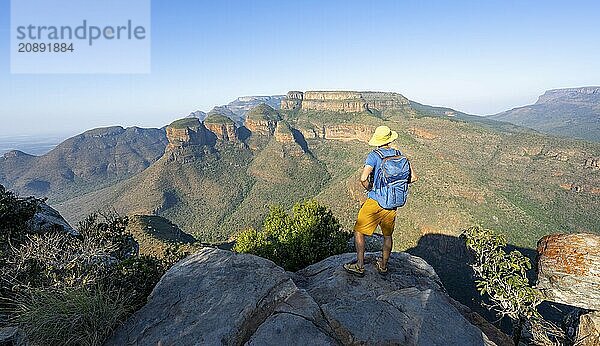 Tourist enjoying the view of the canyon  Blyde River Canyon with Three Rondawels peak  View of canyon with Blyde River and Table Mountains  Canyon landscape in the evening light  Three Rondavels Viewpoint  Panorama Route  Mpumalanga  South Africa  Africa