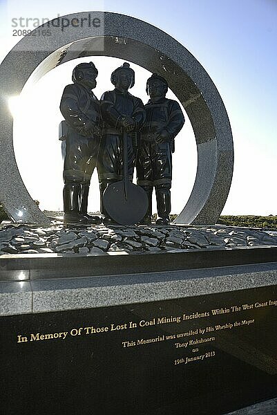 A memorial to coal miners lists the names of men killed in mining accidents in the Greymouth district since 1862. New Zealand  2022. The memorial stands on the Greymouth floodwall and depicts a mine portal with three miners dressed in work clothes