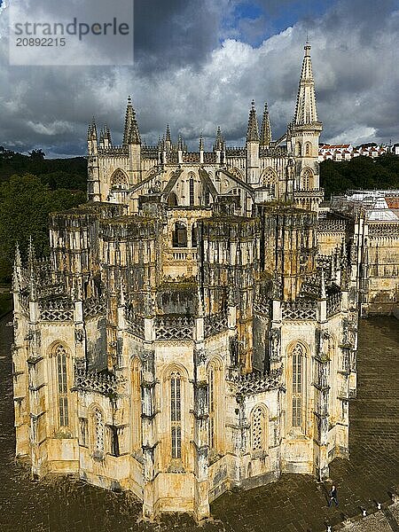 An imposing Gothic cathedral with several towers and a detailed façade under a cloudy sky  aerial view  monastery  Mosteiro de Santa Maria da Vitória  unfinished chapels  UNESCO World Heritage Site  Batalha  Leiria  Estremadura  Portugal  Europe