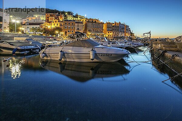 Beautiful historic skyline of a village on the Mediterranean  taken in the morning at sunrise on the beach and by the sea. Dreamlike harbour landscape in Mošcenicka Draga  Moscenicka Draga  Istria  Croatia  Europe