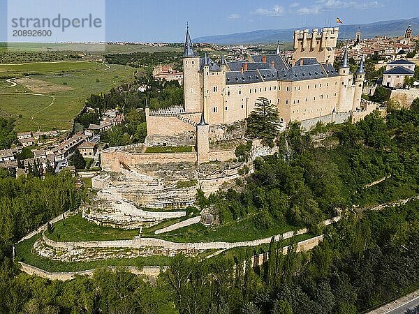 Historic castle on a hill with many towers  surrounded by green areas and walls  aerial view with wide panoramic view  aerial view  Alcázar  Alcazar  Segovia  Castilla y León  Leon  Spain  Europe