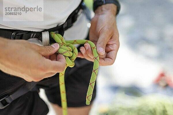 Subject: A climber ties himself / herself into a rope to climb on the rock  Morsbach  09.07.2024