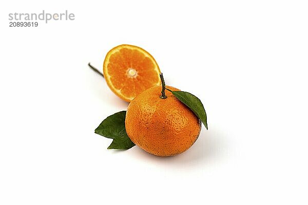 An orange fruit  orange slices  and orange leaves are isolated on a white background