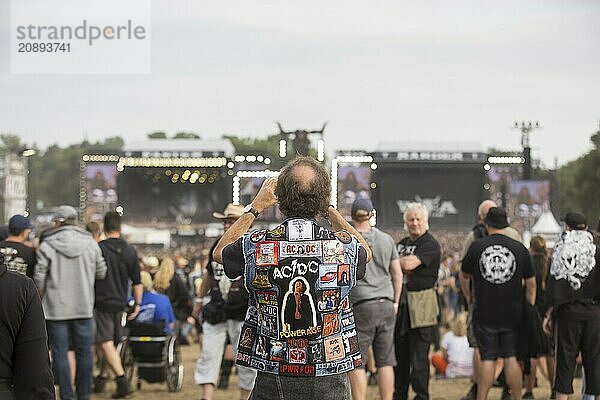 An elderly gentleman photographs the two main stages at the Wacken Open Air in Wacken. The traditional metal festival takes place from 31 July to 3 August 2024