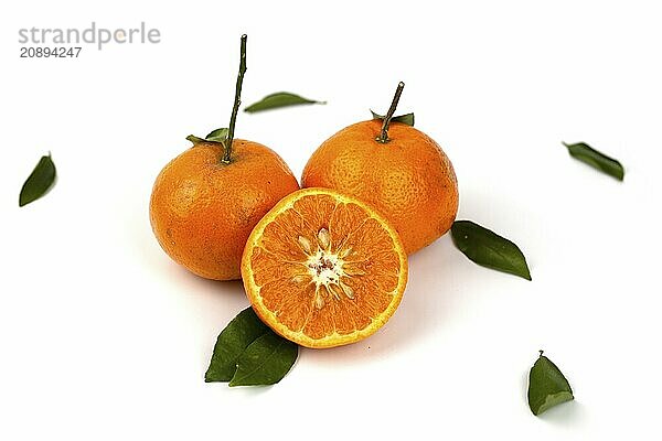 An orange fruit  orange slices  and orange leaves are isolated on a white background