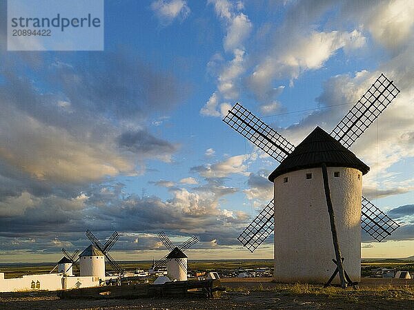 Several windmills stand in an open landscape under a dramatic sky at sunset  Windmills  Campo de Criptana  Ciudad Real province  Castilla-La Mancha  Route of Don Quixote  Spain  Europe