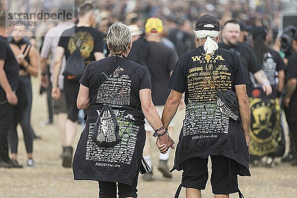 Elderly couple with Wacken shirts at the Wacken Open Air in Wacken. The traditional metal festival takes place from 31 July to 2 August 2024