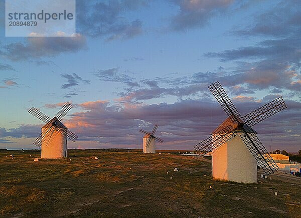 Three windmills stand on a vast landscape under a pink and blue sky during sunset  aerial view  windmills  Campo de Criptana  Ciudad Real province  Castilla-La Mancha  Route of Don Quixote  Spain  Europe