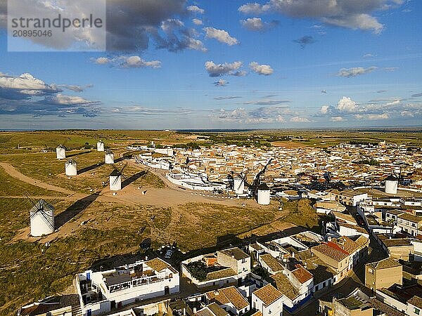 Aerial view of a village with several windmills and houses under a blue sky with clouds  aerial view  windmills  Campo de Criptana  Ciudad Real province  Castilla-La Mancha  Route of Don Quixote  Spain  Europe