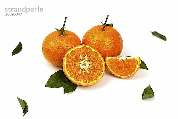 An orange fruit  orange slices  and orange leaves are isolated on a white background