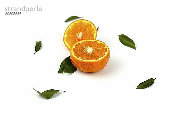 An orange fruit  orange slices  and orange leaves are isolated on a white background