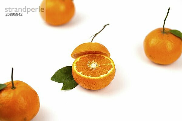 An orange fruit  orange slices  and orange leaves are isolated on a white background