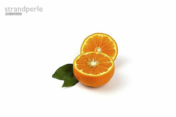 An orange fruit  orange slices  and orange leaves are isolated on a white background