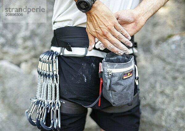 A climber uses so-called chalk (magnesium) in front of climbing a route on the rock  in Morsbach  09.07.2024