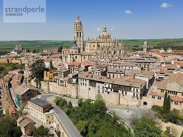 Panorama of a medieval city with a large church surrounded by historic buildings and nature under a blue sky  aerial view  Cathedral  Alcázar left  Alcazar  Segovia  Castilla y León  Leon  Spain  Europe