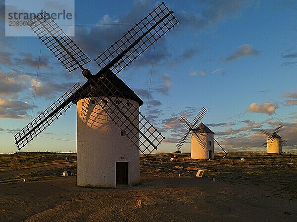 Several windmills at sunset in an open landscape under a cloudy sky  windmills  Campo de Criptana  Ciudad Real province  Castilla-La Mancha  Route of Don Quixote  Spain  Europe