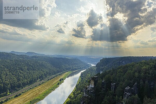 The Bastei is a rock formation with a viewing platform in Saxon Switzerland on the right bank of the River Elbe in the municipality of Lohmen between the spa town of Rathen and the town of Wehlen. It is one of the most visited tourist attractions in Saxon Switzerland. Dramatic sky over the Bastei  Saxon Switzerland  Rathen  Saxony  Germany  Europe