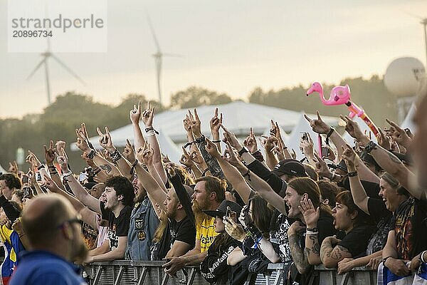 Festival-goers in the front row give the devils salute at the Wacken Open Air in Wacken. The traditional metal festival takes place from 31 July to 3 August 2024