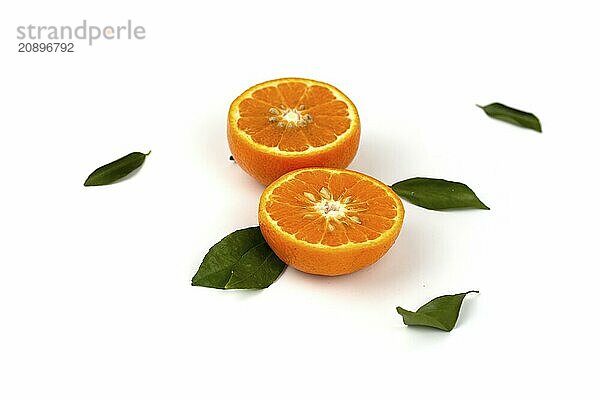 An orange fruit  orange slices  and orange leaves are isolated on a white background