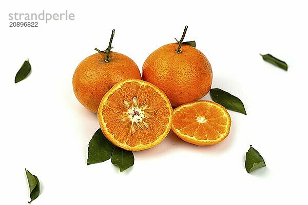 An orange fruit  orange slices  and orange leaves are isolated on a white background