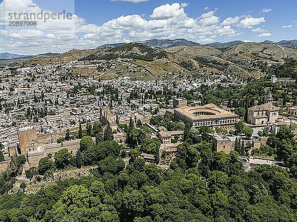 View of a city with historic buildings and lush vegetation in a hilly landscape  aerial view  Alhambra  Andalusia  Granada  Spain  Europe