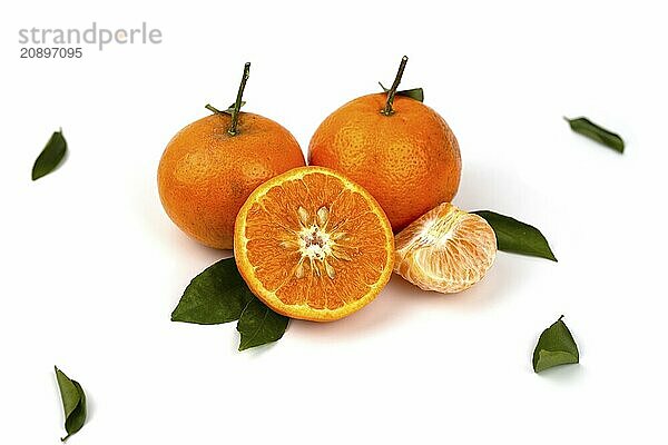 An orange fruit  orange slices  and orange leaves are isolated on a white background