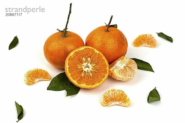 An orange fruit  orange slices  and orange leaves are isolated on a white background