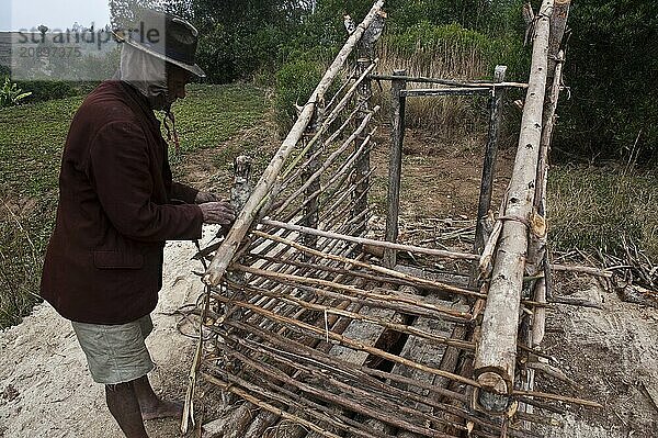 Man building toilets (Near Ambositra  Madagascar)  He belongs to the Betsileo ethnic group